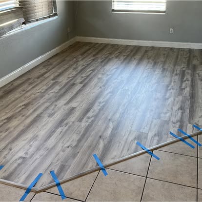 New wood-look plank flooring meeting tile with a transition strip